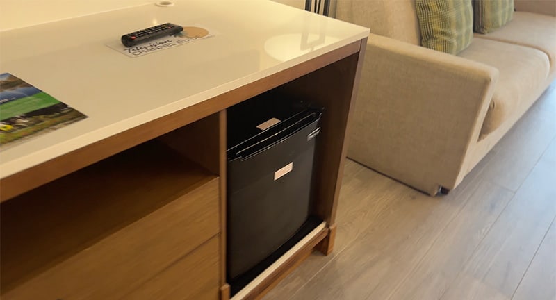 Dresser and mini fridge inside a Shades of Green guest room