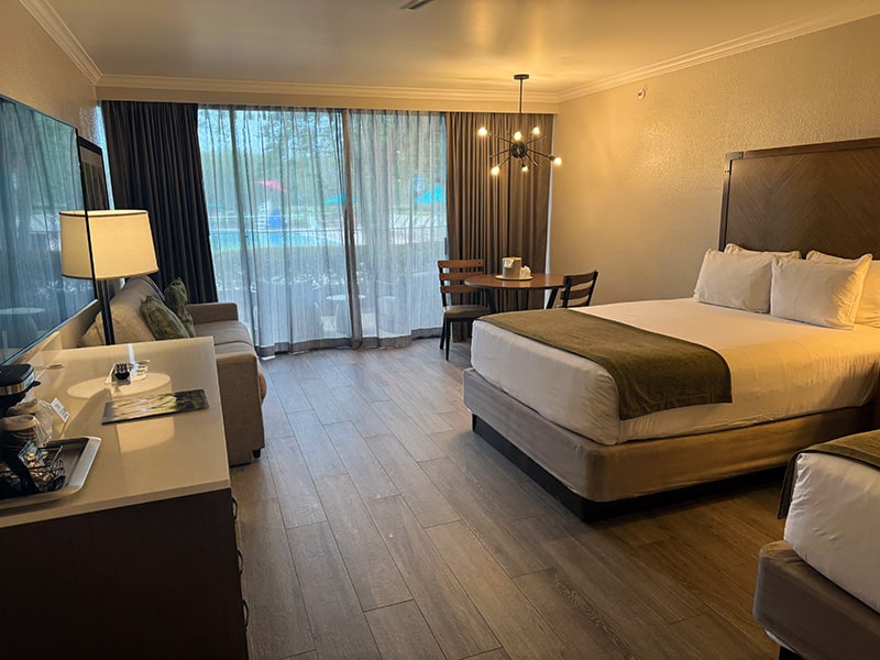 Spacious Shades of Green guest room with two queen beds and seating area
